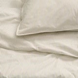 Striped cotton sheets, neatly folded, showing quality stitching and texture.