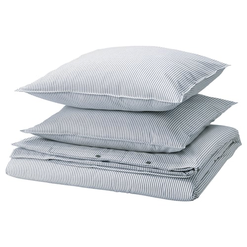 Three stacked SOLFIBBLA pillows, light blue with white stripes, rectangular shape.