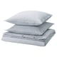 Three stacked SOLFIBBLA pillows, light blue with white stripes, rectangular shape.