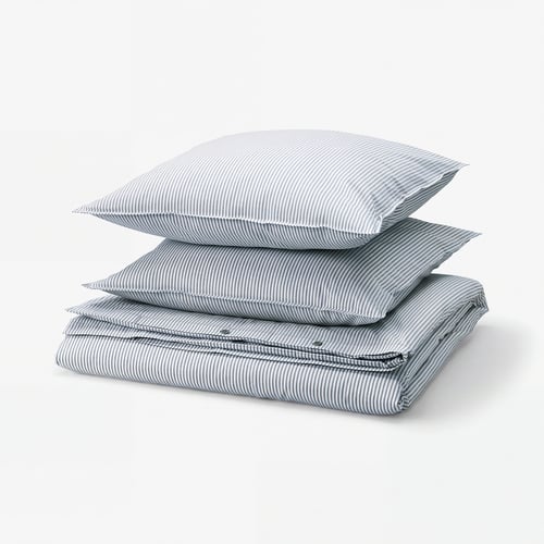 Stacked blue-and-white striped linens, including pillowcases and duvet cover, made of 100% cotton.