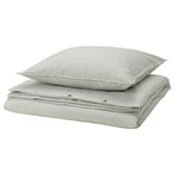 Stacked green striped bed linens: duvet cover and two pillowcases in cotton.