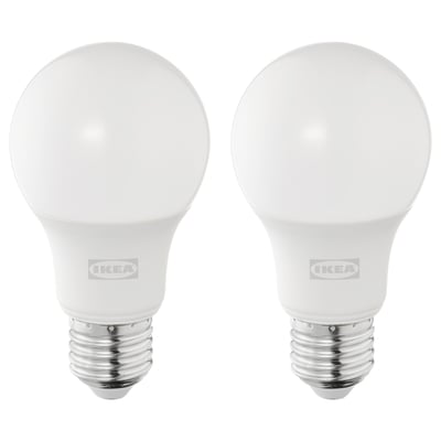 Two ikea led bulbs, white, round shape, silver base, stand upright, brand visible.