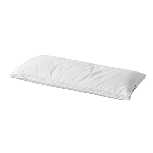 A white strandmolne pillow, rectangular, with soft fabric and double piping for comfort.