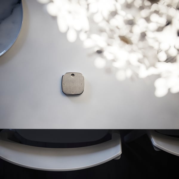 Small, square, silver STYRBAR remote on white device.