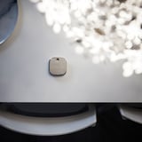 Small, square, silver STYRBAR remote on white device.