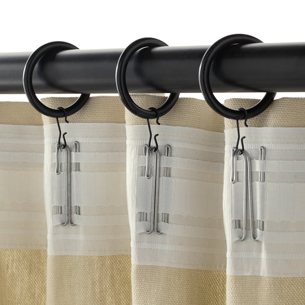 Black curtain rings with clips hanging curtains.