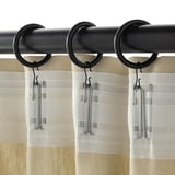 Black curtain rings with clips hanging curtains.