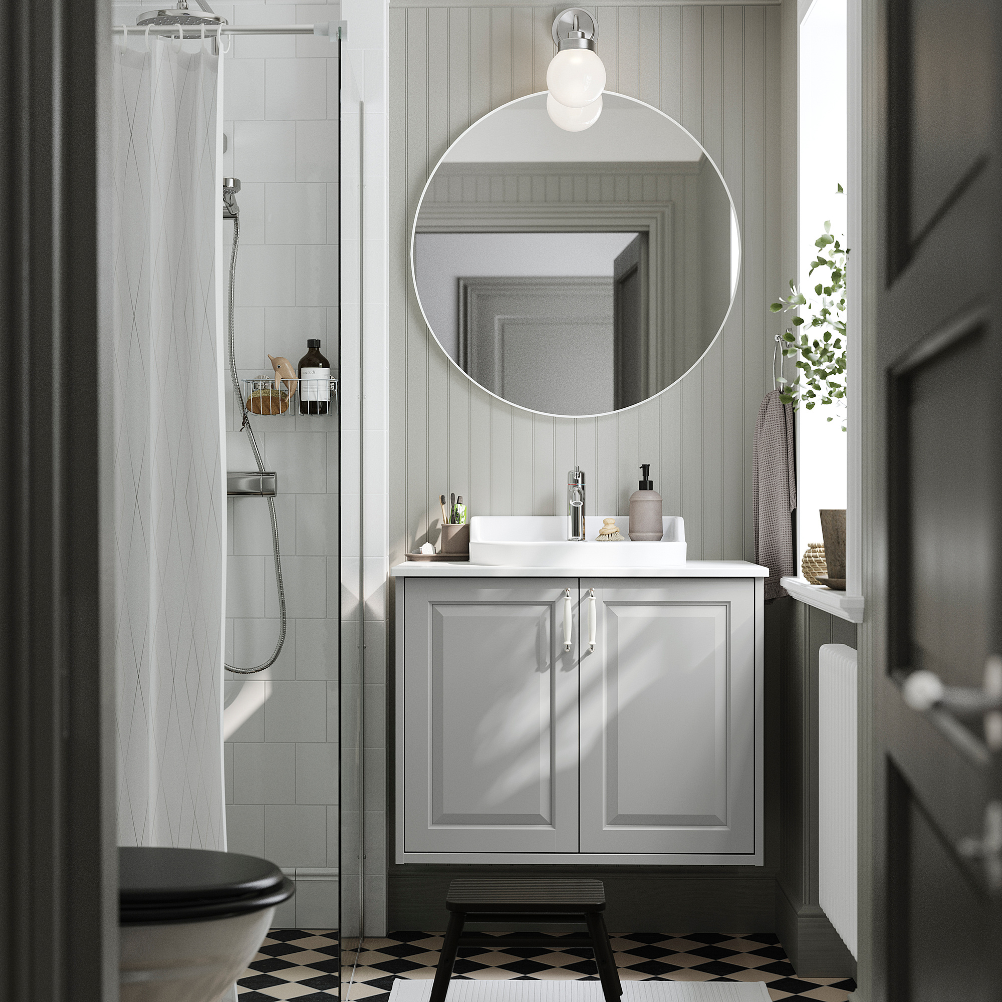 Modern gray bathroom with TÄNNFORSEN vanity, round mirror, and checkered floor.
