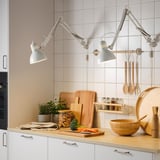 Kitchen with TERTIAL lamps on wooden counter.