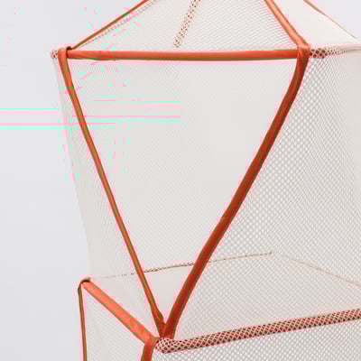 Close-up of orange mesh chairs sturdy frame and webbing detailing.