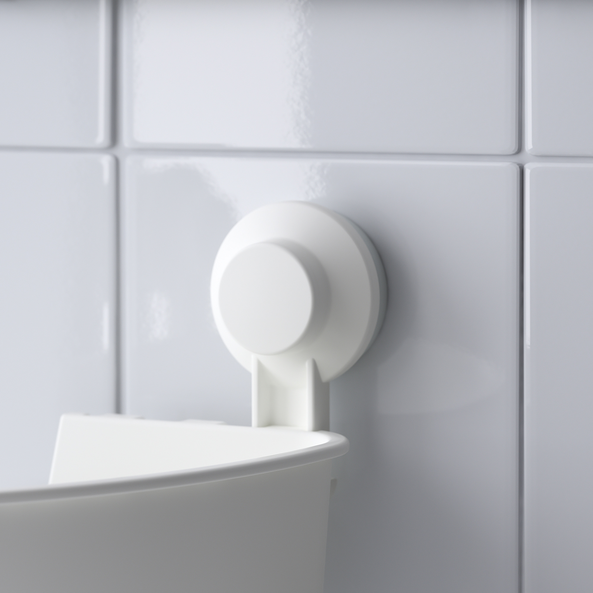 Suction-mounted organizer: sleek, white, attached to tiled wall, part of TISKEN series, designed for efficient storage.
