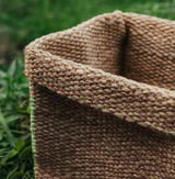 Handwoven brown jute basket, soft shape, fits kallax shelf.