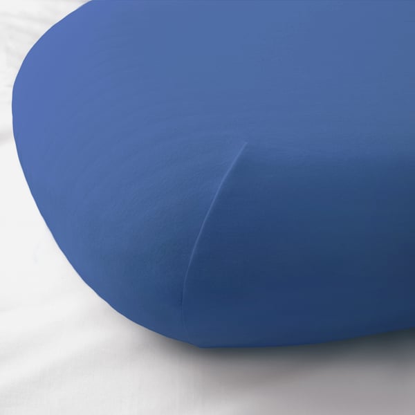A close-up of a blue pillowcase with a soft, stretchy fabric and elastic hem.