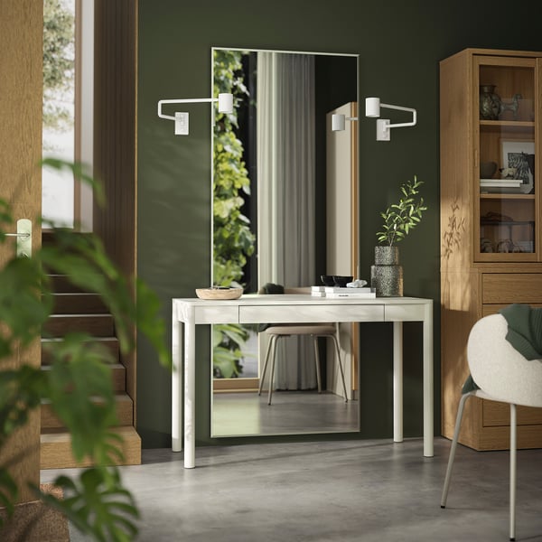 Modern green room with white TONSTAD desk, mirror, and chair. Wood and acrylic materials, minimalist design.