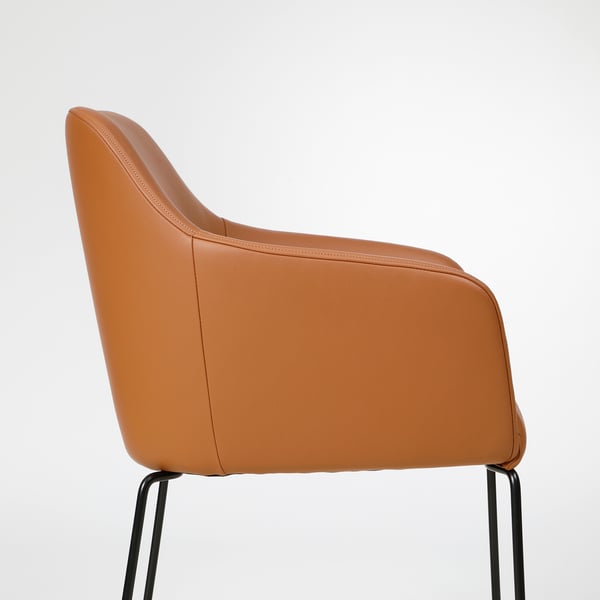 Tan leather cushioned chair with sleek armrests and sturdy metal legs.