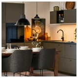 Modern kitchen with TOSSBERG chairs, black fabric, hanging lamps, wooden table, crockery, and gray cabinets.