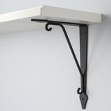 White wooden shelf with black metal bracket, securely mounted on wall. Clean design, sturdy support.