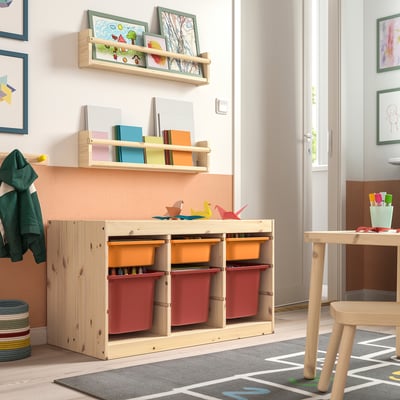 Playback TROFAST childrens storage. Wooden frame, colourful boxes. Centred, low, rectangular. Smaller than wall art, larger than stools.