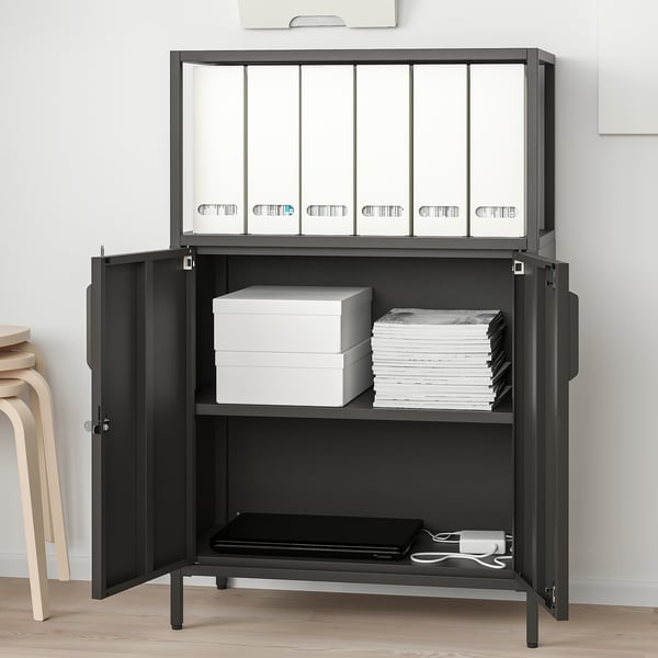 Black metal storage cabinet with adjustable shelves, holding file folders, boxes, and papers.
