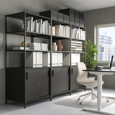 Modern office with TROTTENtall shelf, books, and desk.