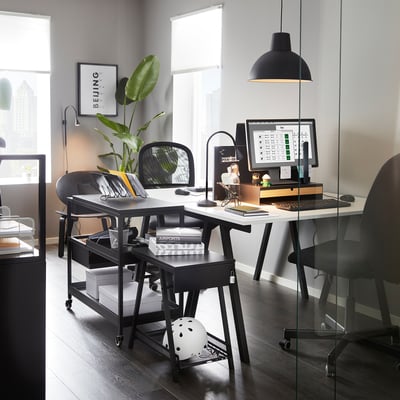 Modern home office with TROTTEN storage under l-desk and plants.