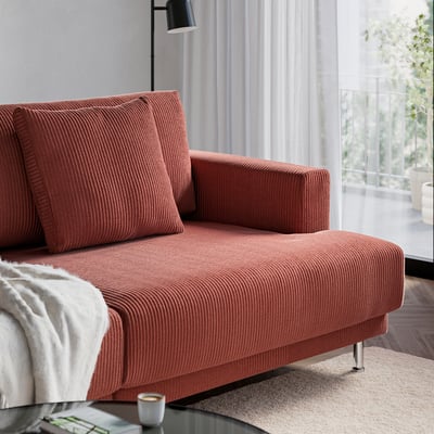 Bright living room with a red UPPÅKRA sofa, featuring soft cushions and a cosy, relaxed environment.