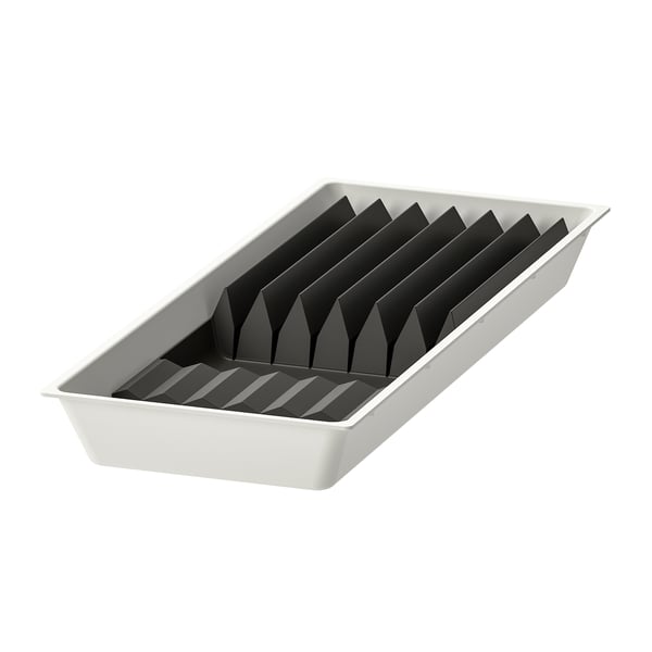 Rectangular white plastic organizer with black rubber inserts, divided for knife storage.