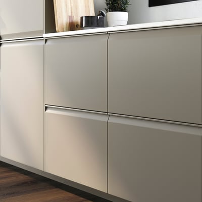 Modern kitchen with beige UPPLÖV cabinets, sleek handles, and a wooden countertop with items.