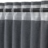 Close-up of grey curtains on black rod, with textured fabric and horizontal pleats.