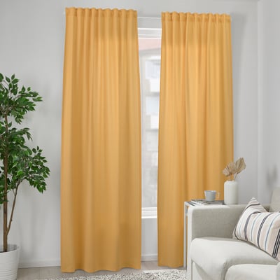 Yellow VÄXELBRUK curtains, recycled cotton-polyester, hang near chair & plant, cozy & modern.