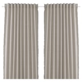 Two beige curtains hang side by side. Made from recycled materials with fringe detailing. Simple, lightweight, and pleated.