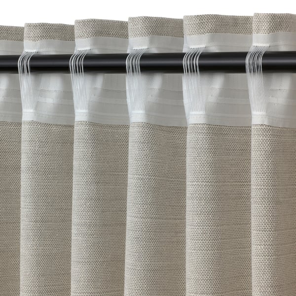 Light filtering curtain with textured design and fringe detail.