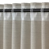 Light filtering curtain with textured design and fringe detail.