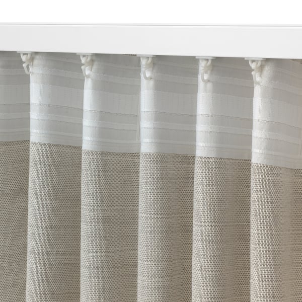 Close-up of textured curtain with horizontal stripes, secured with white hooks.