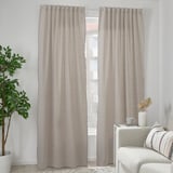Grey curtains with white fringes near white sofa, eco-friendly, recycled.