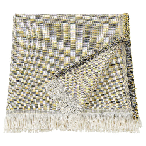 The VÄXELBRUK throw blanket is light brown and light grey with colourful fringes, rectangular shaped, made from recycled work clothes.