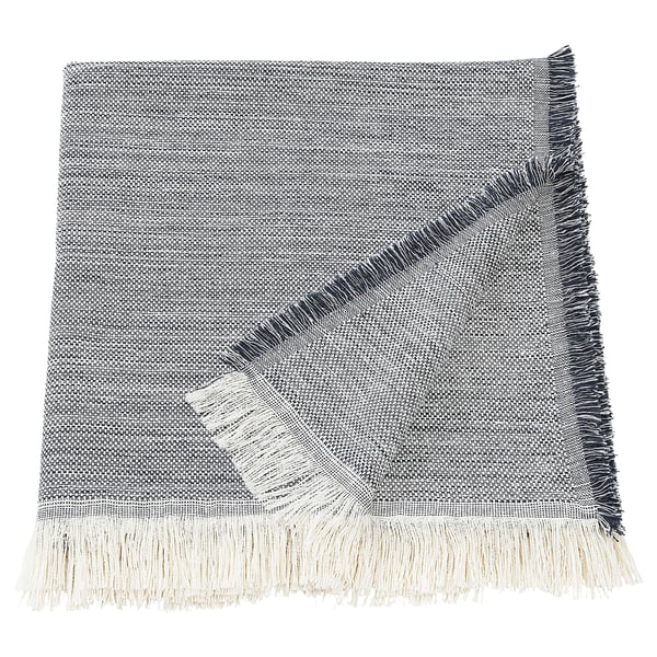 The VÄXELBRUK throw, featuring recycled work clothes with blue, grey, and yellow fringes.
