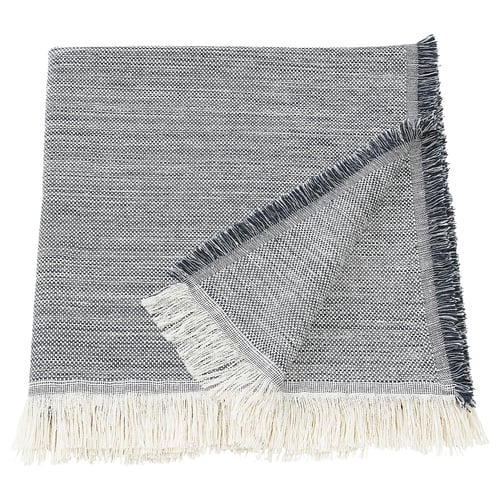 The VÄXELBRUK throw, featuring recycled work clothes with blue, grey, and yellow fringes.