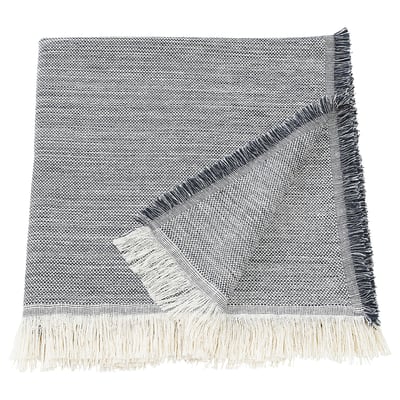 The VÄXELBRUK throw, featuring recycled work clothes with blue, grey, and yellow fringes.