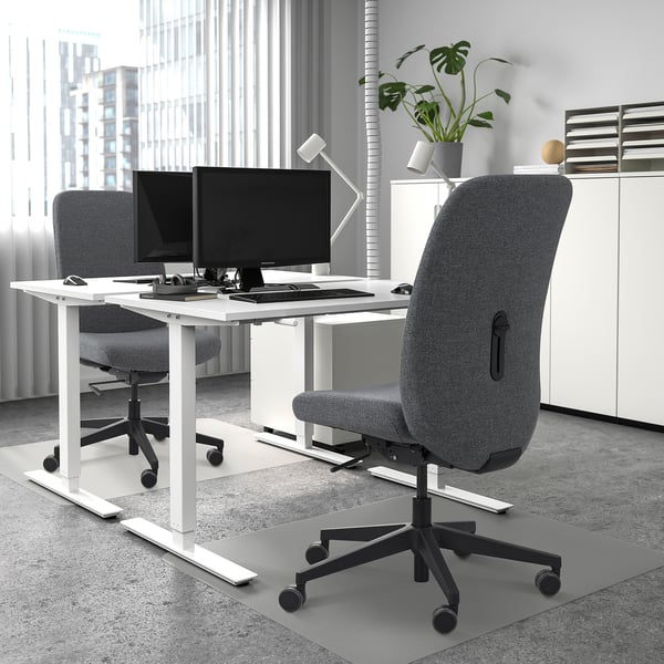 Modern office with VALLFJÄLLET desk and chair, dual monitors, city view.
