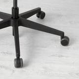 Close-up of sturdy, black office chair base with smooth-rolling casters on light wooden floor.
