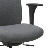 Close-up of ergonomic office chair showing high-quality fabric, adjustable armrest, and supportive seat and backrest.
