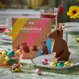 IKEA chocolate bunny kit displayed on a table with easter eggs. The boxed kit shows a milk chocolate bunny ready to be assembled.