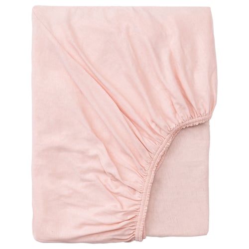 A peach-colored, soft cotton fitted bed sheet, neatly folded, with elastic edging for a secure fit.