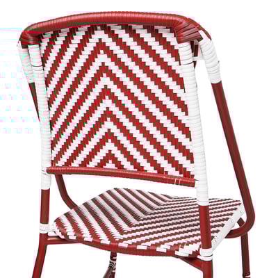 Red and white wicker chair, expertly woven, with sturdy red metal frame. Ideal for outdoor dining.