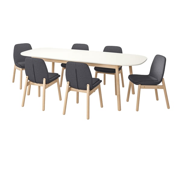 Modern white oval dining table with six light wood and dark gray chairs.