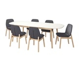 Modern white oval dining table with six light wood and dark gray chairs.