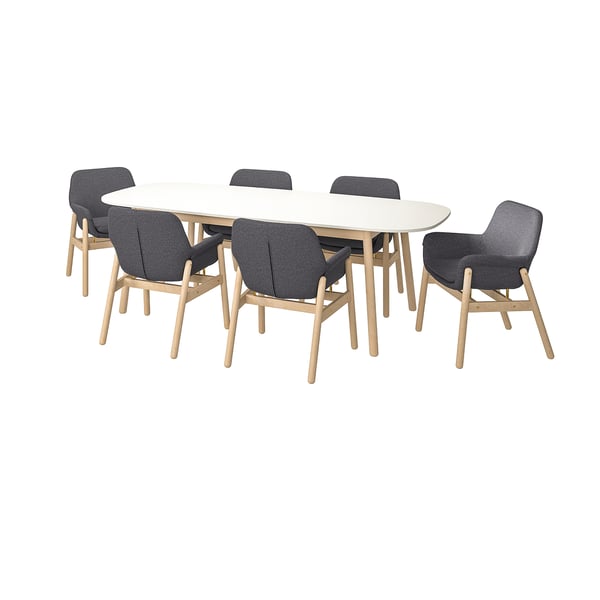 Modern dining set with 6 gray chairs and white oval table, sleek wooden legs.