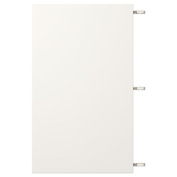 White VEDDINGE cabinet door with nickel hinges.