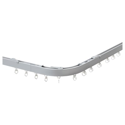 Silver VIDGA curved curtain rail with hooks for corner windows.